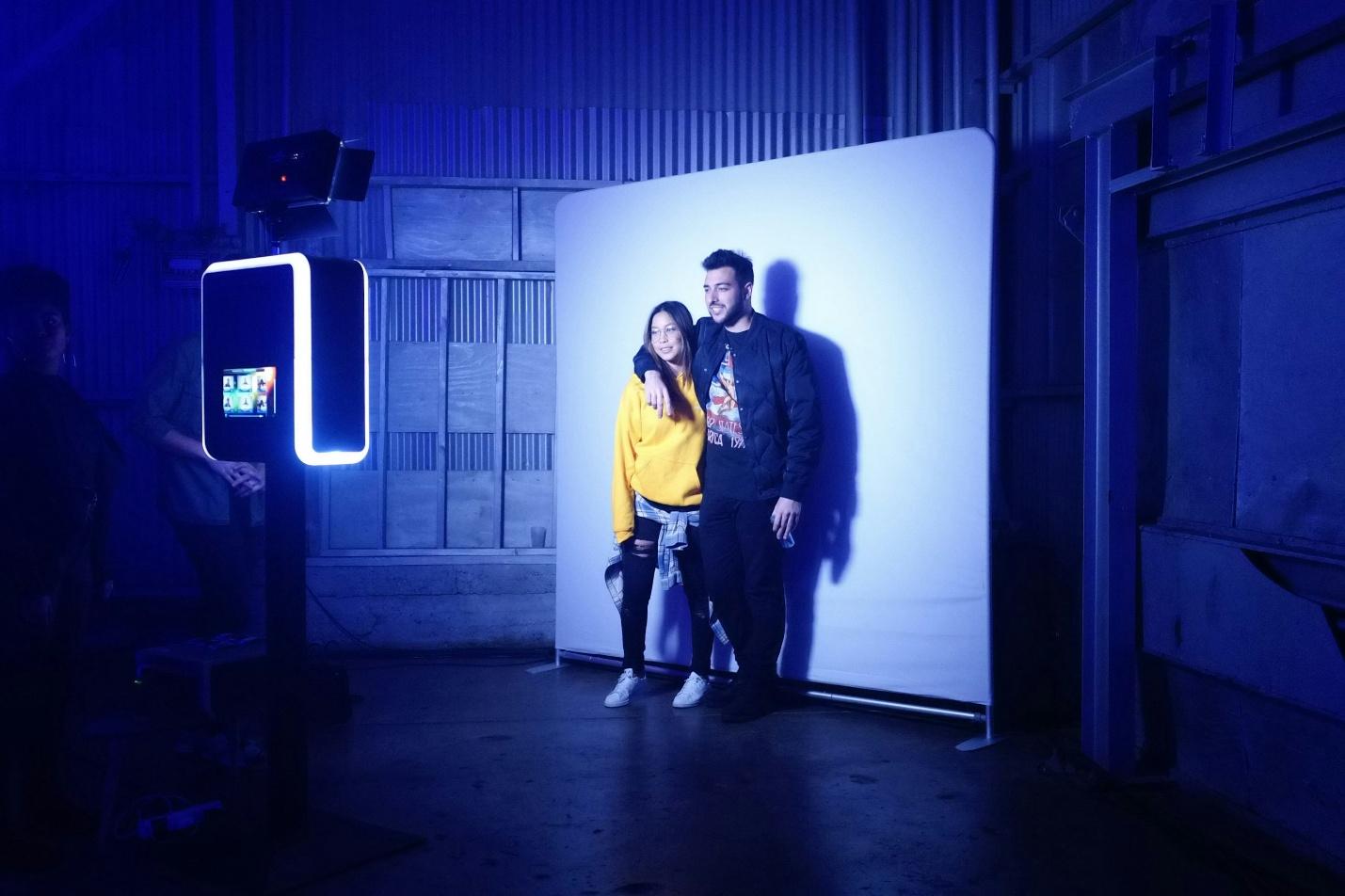 A man and a woman standing in front of a wall