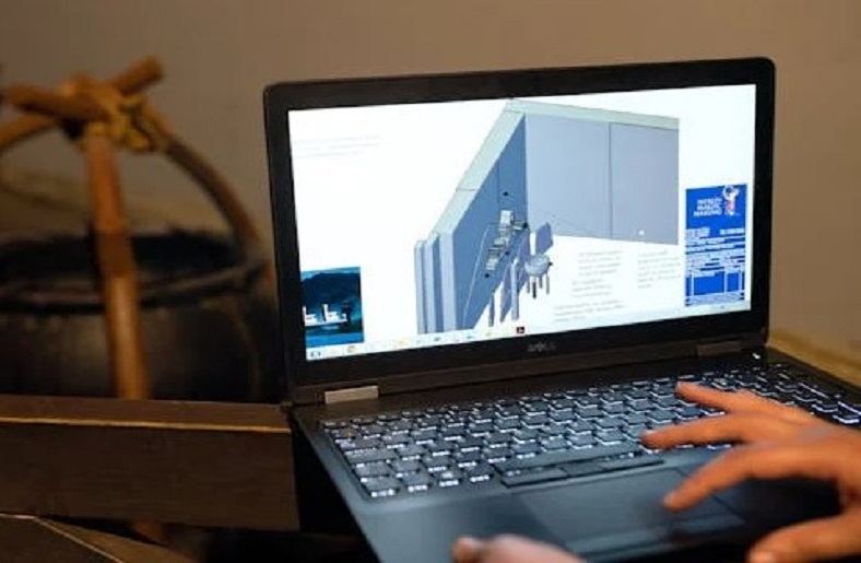 Laptop showing 3D architectural design.






