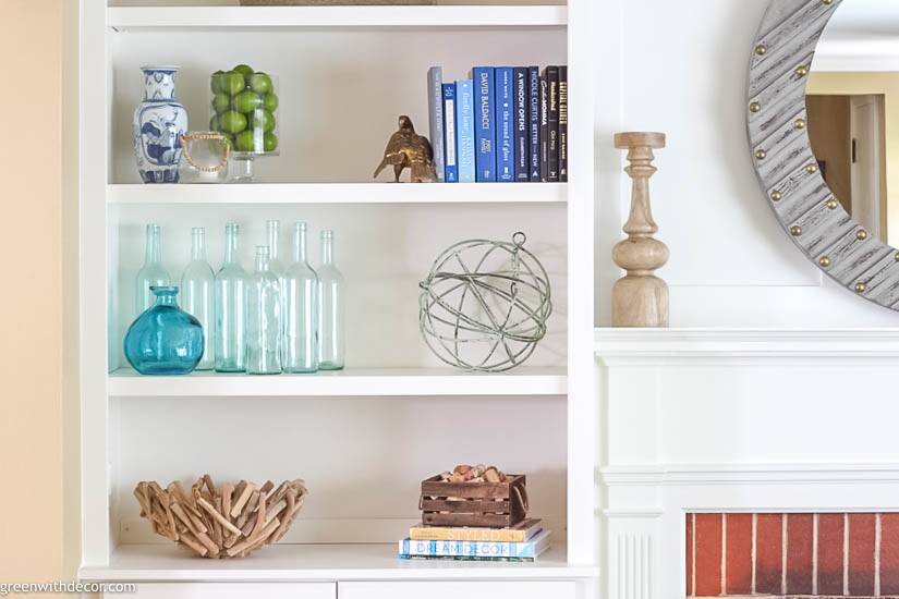 a white shelf with objects on it
