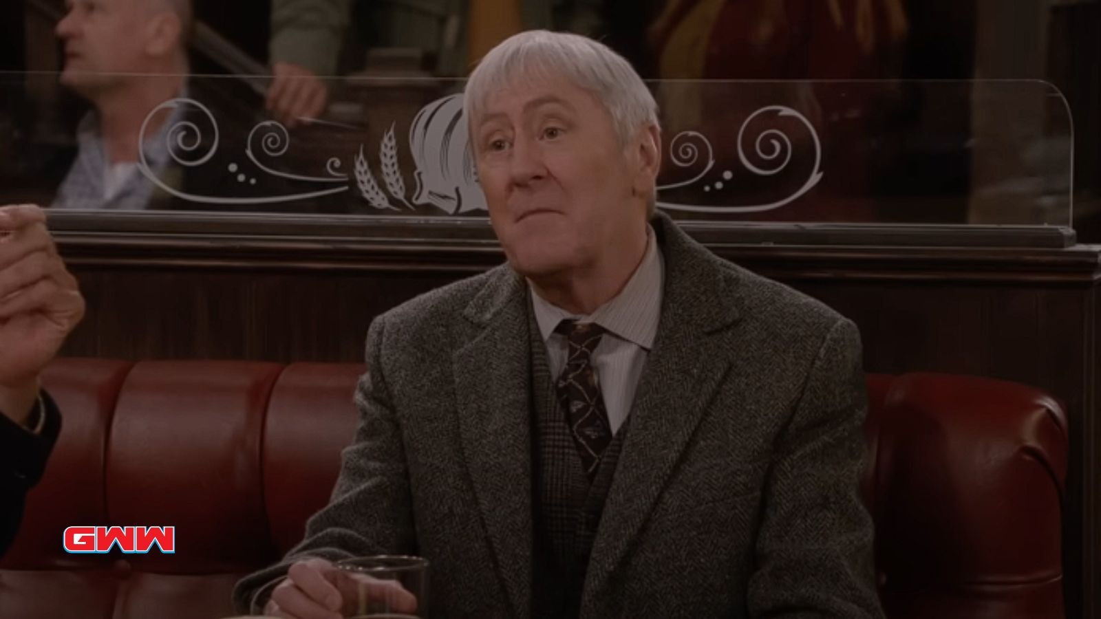  Nicholas Lyndhurst sitting in a bar, looking thoughtful with a drink.