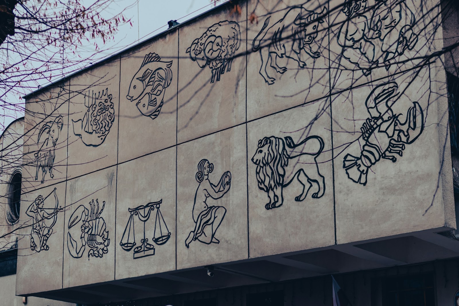 Zodiac signs on building wall.