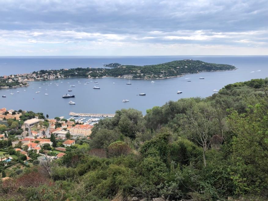 A body of water with boats and buildings in the distance

Description automatically generated