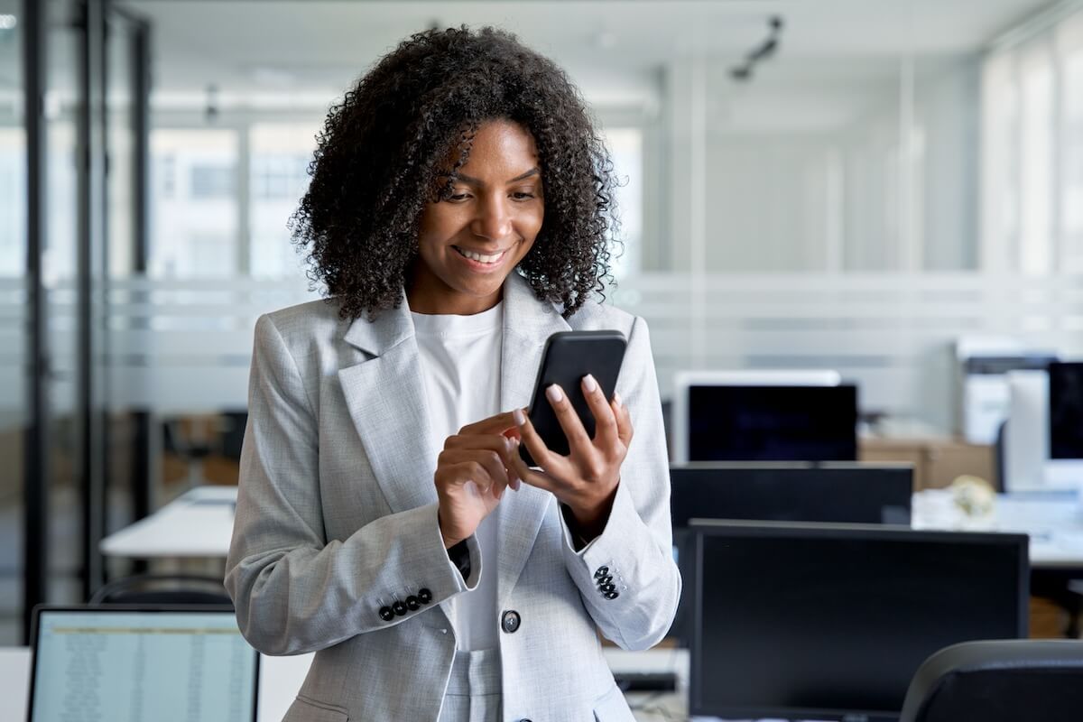 Curly-haired employee using her phone