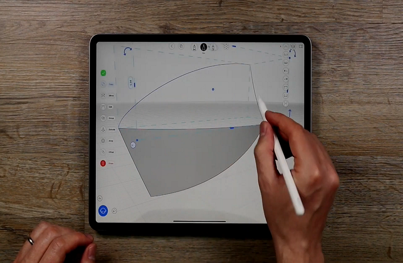 Hand using a stylus to sketch on a tablet.






