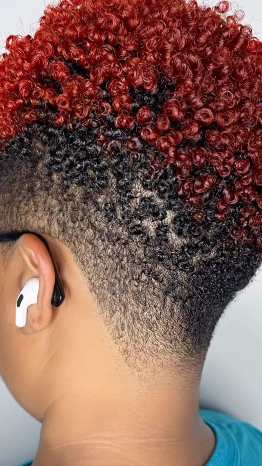 a red edgy short hair featuring an undercut