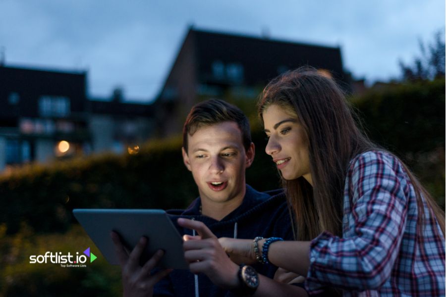 Two young people looking at a tablet screen together.