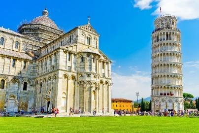 A leaning tower of pisa and a buildingDescription automatically generated