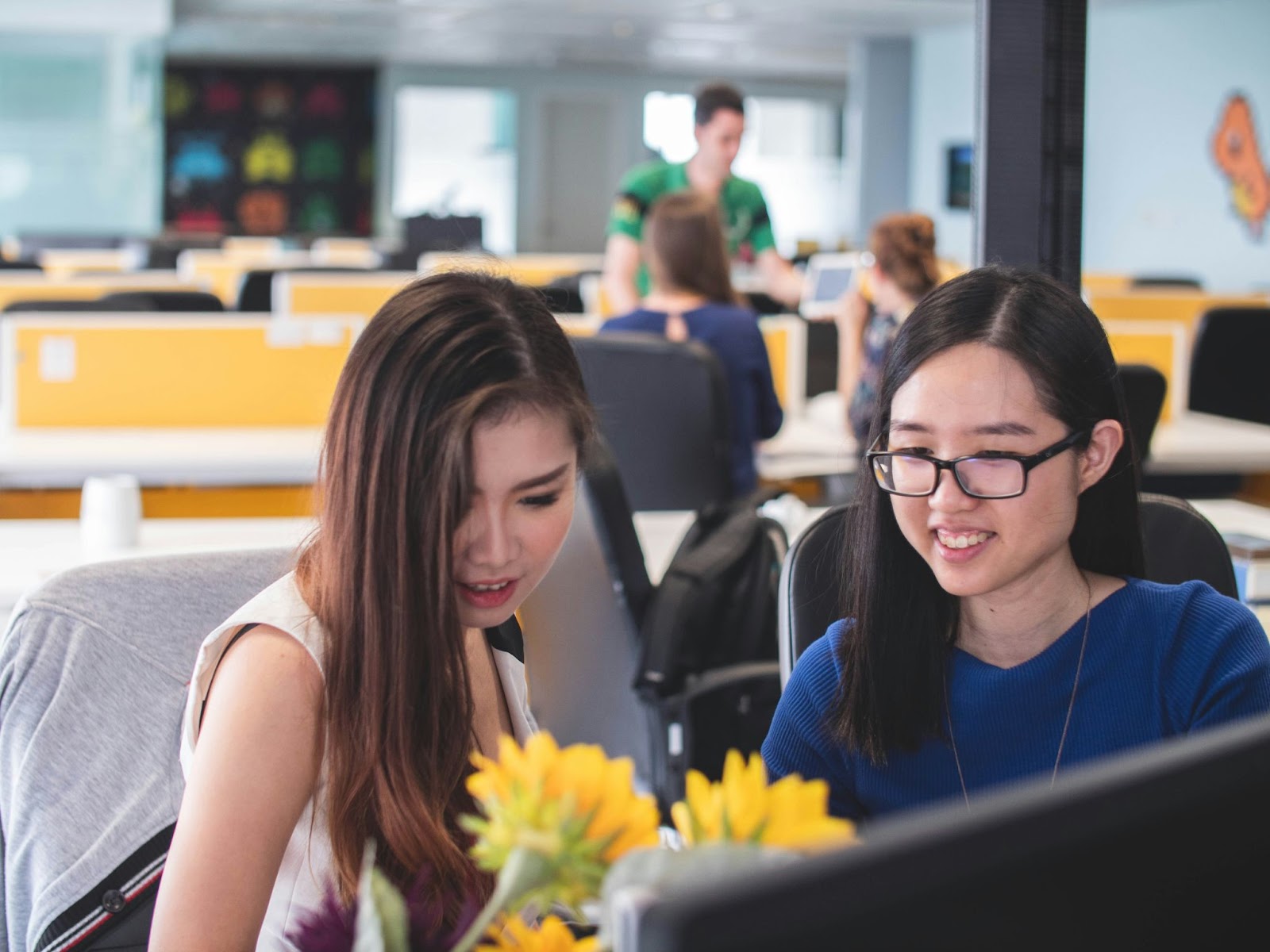 Two female colleagues working together in an office