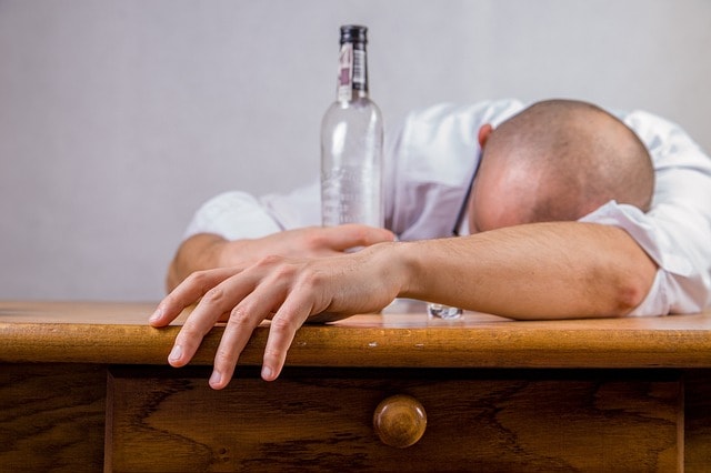 A man suffers from excessive alcohol consumption, seeking treatment can prevent further alcohol abuse