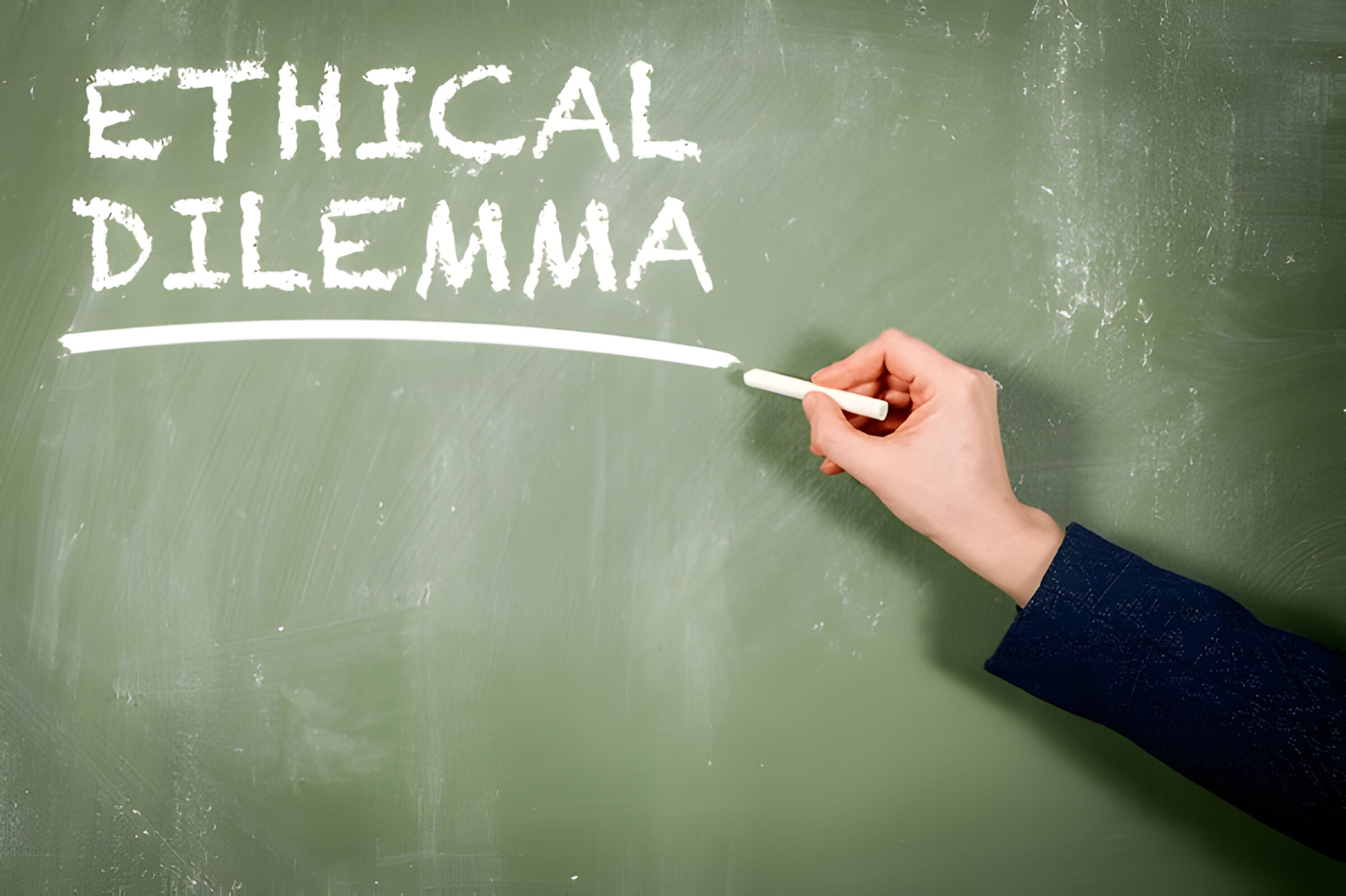 Hand writing 'Ethical Dilemma' on a chalkboard, representing the challenges accountants face in making ethical decisions