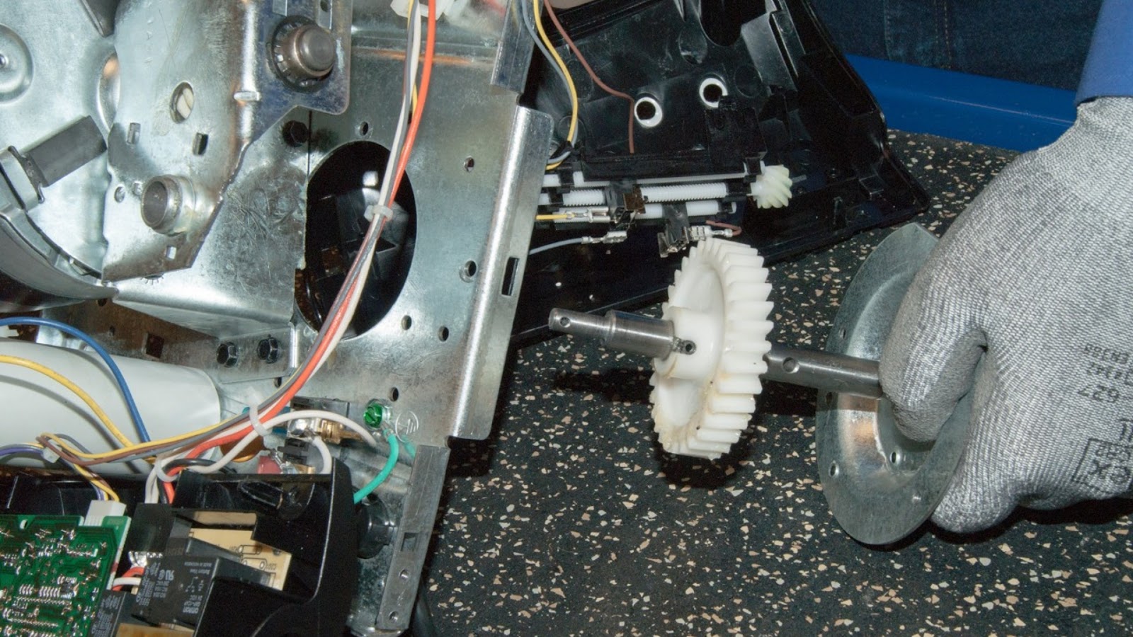 Replacing a broken gear and sprocket for a garage door opener.