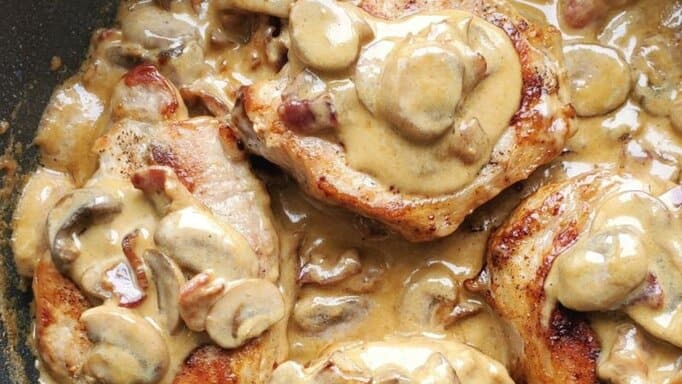 Bacon Mushroom Pork Chops in a pan.