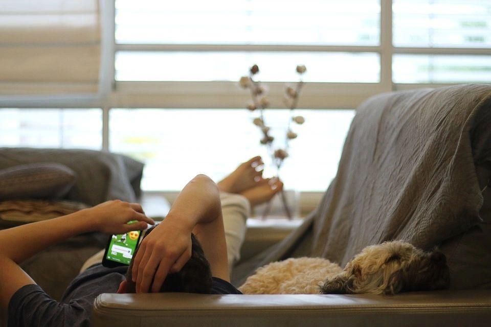 boy lying with his dog on the sofa