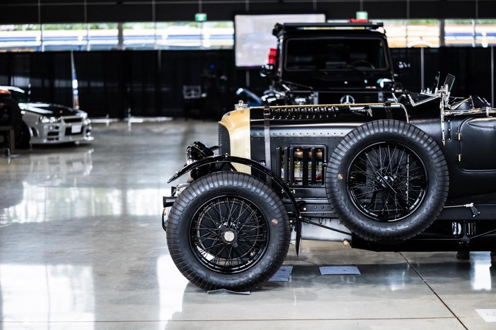 A black and gold car in a showroom

AI-generated content may be incorrect.