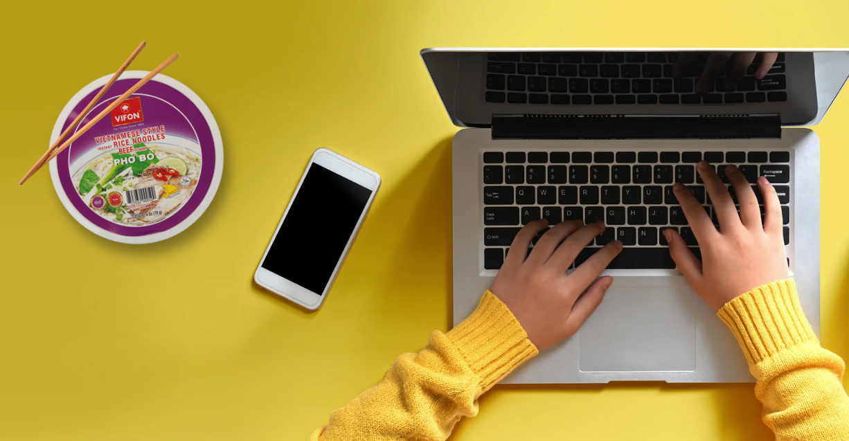(Lunch break essentials: a bowl of VIFON Pho, your laptop, and a cozy sweater—fueling productivity one bite at a time.)
