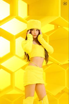 This contain a picture of MAMAMOO's Solar in yellow outfit and boots posing for the camera with her hand on her head