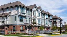 This contains a row of multi - family houses on the corner of a street in an urban area