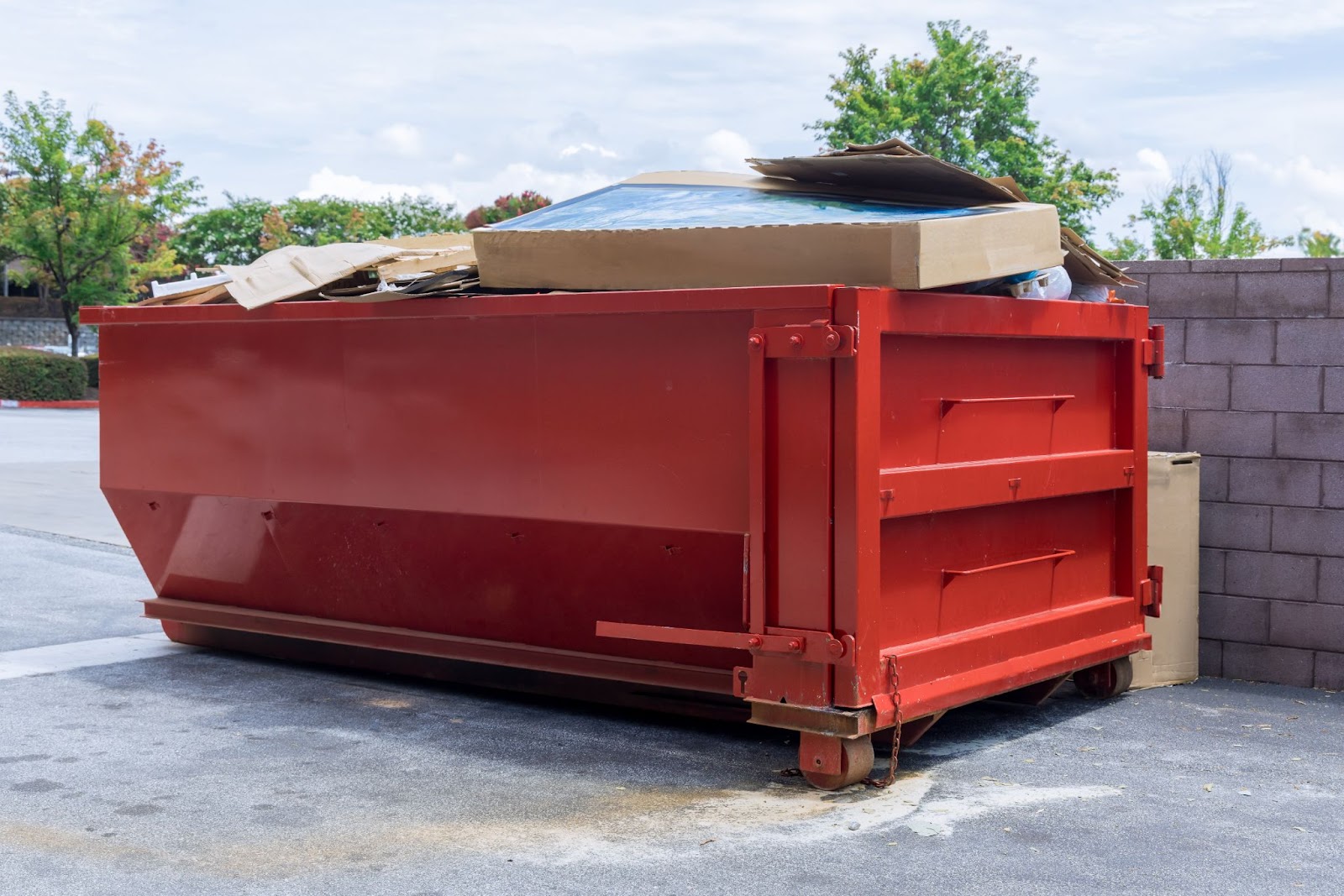 A bright orange dumpster full of construction debris.