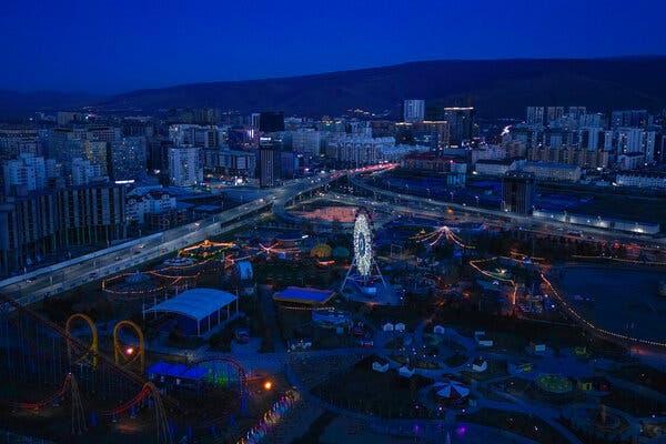 An aerial view of a sprawling cityscape at twilight.