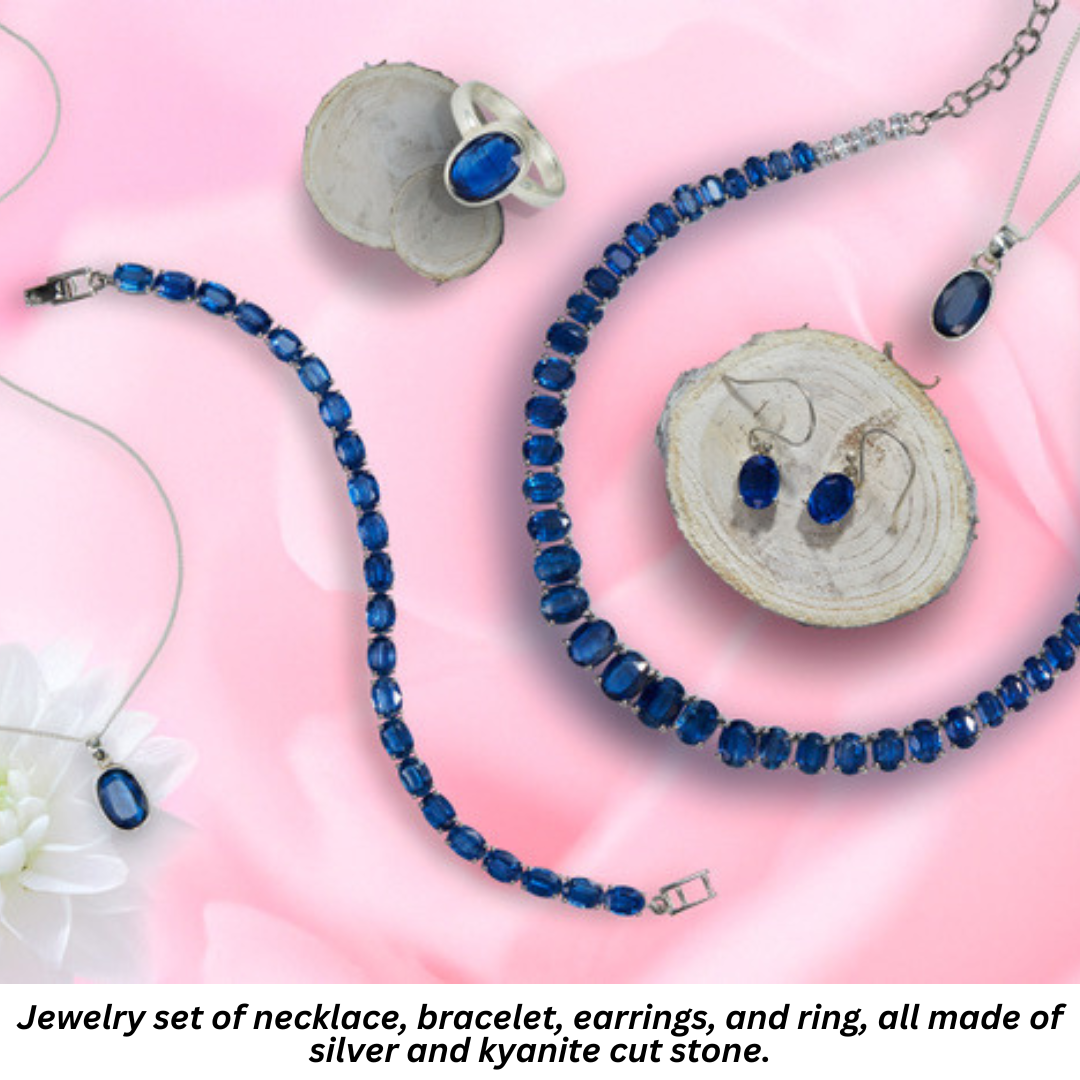 Jewelry set of necklace, bracelet, earrings, and ring, all made of silver and kyanite cut stone.