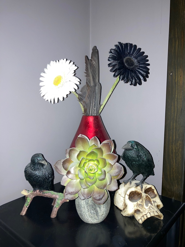 An arrangement of corvids, flowers, and a succulent.