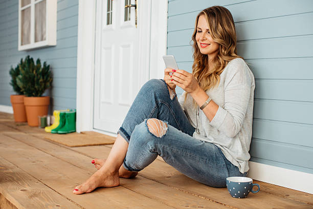 Woman smiling while looking at her cellphone