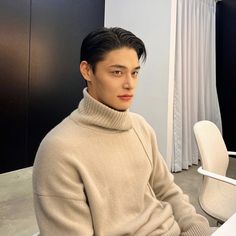 This  contain an image Model Jung Hyuk sitting at a desk in front of a laptop computer and wearing a turtle neck sweater