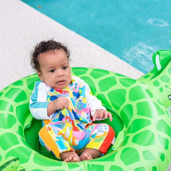 Baby boy in a Joyful sunsuit by SwimZip by the pool—Sun safety: Useful tips for kids (and parents)