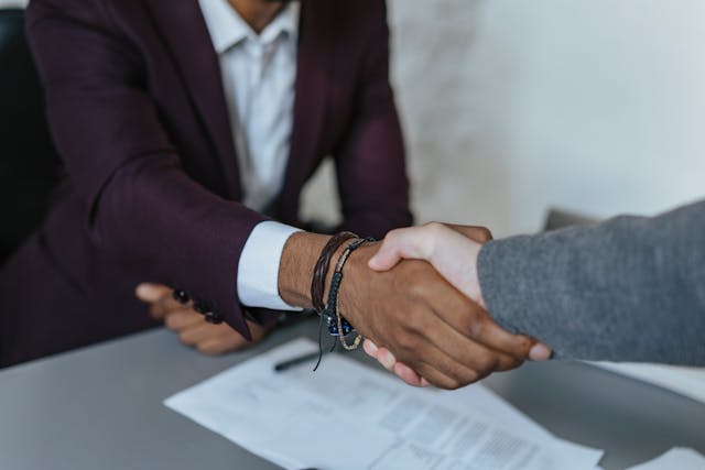 two people shaking hands 