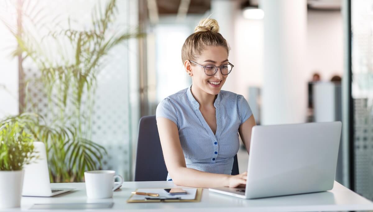 Employee wearing a pair of eyeglasses, using a laptop