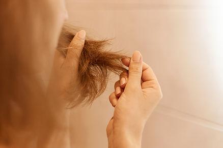 A female holding her hair's