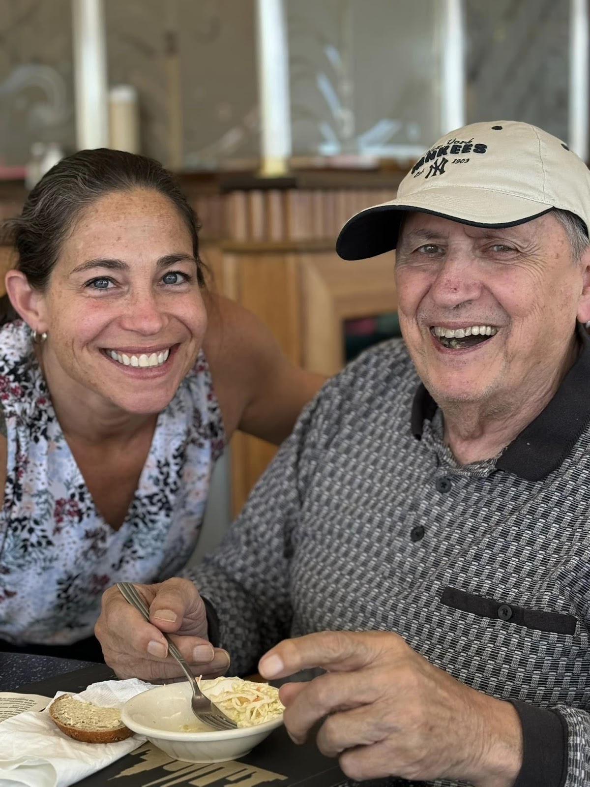 A picture of a man smiling with a woman next to her who is also smiling