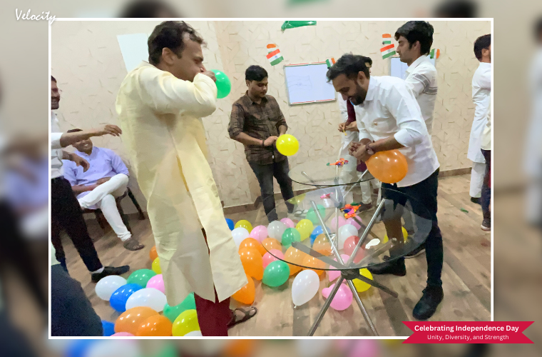 Two team members at Velocity participating in the Balloon Blow Challenge