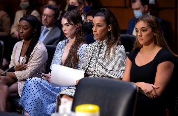 A group of women sitting in chairs

Description automatically generated