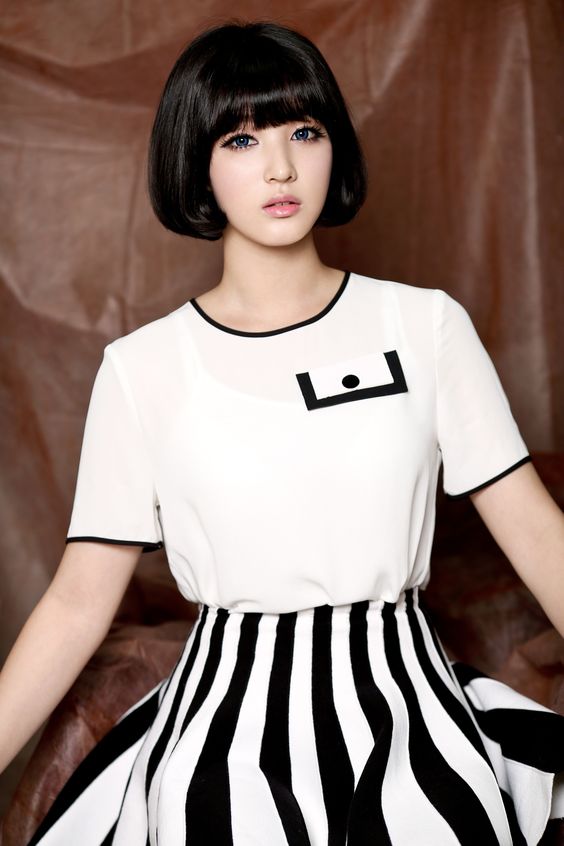 This contains a picture of  LABOUM member Yulhee  with black and white stripes on her dress