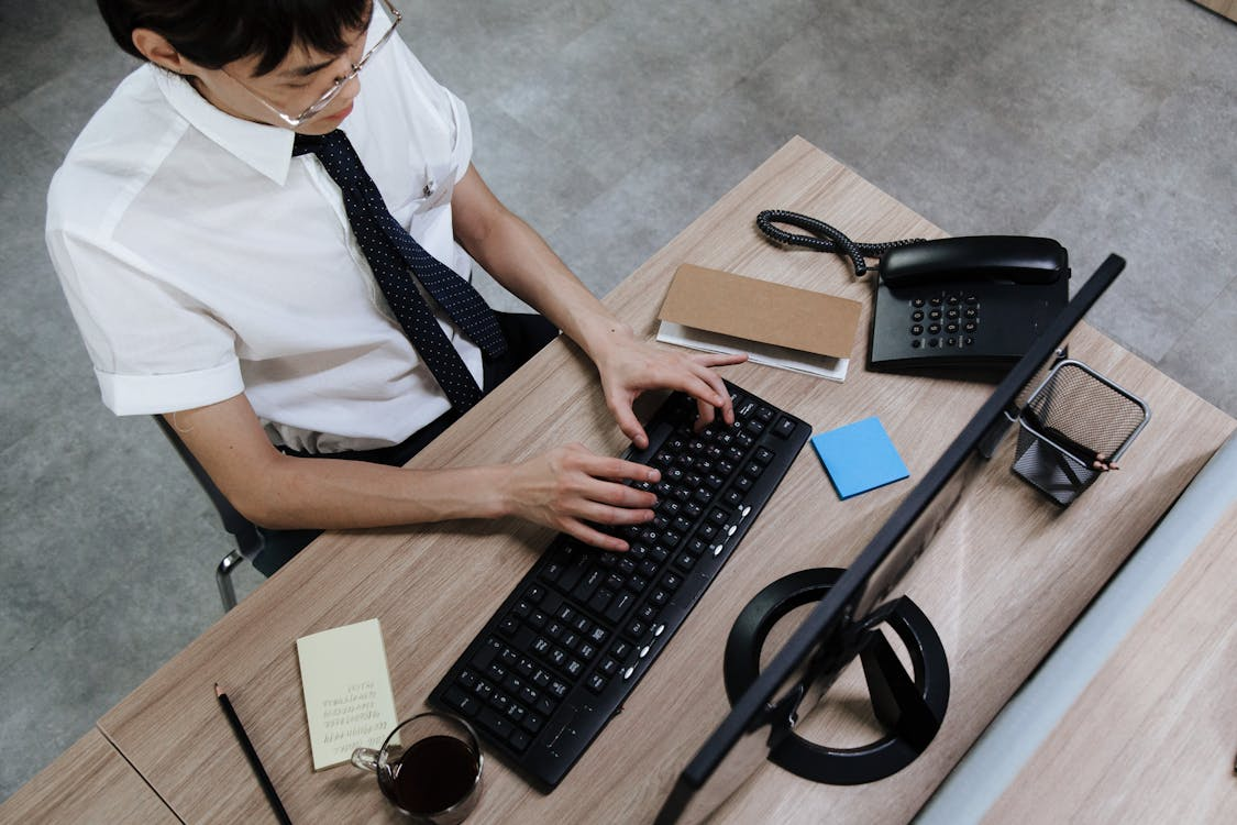 an employee typing on his keyboard