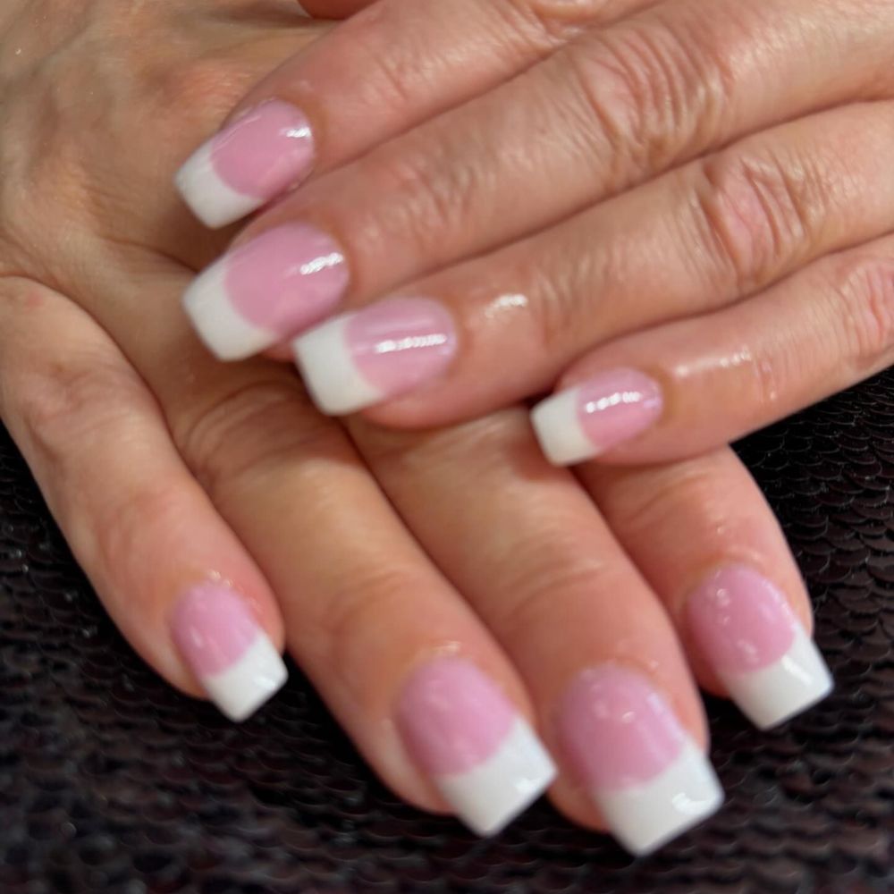 Close up of nails with simple pink nail designs having Solar Pink and White Nails