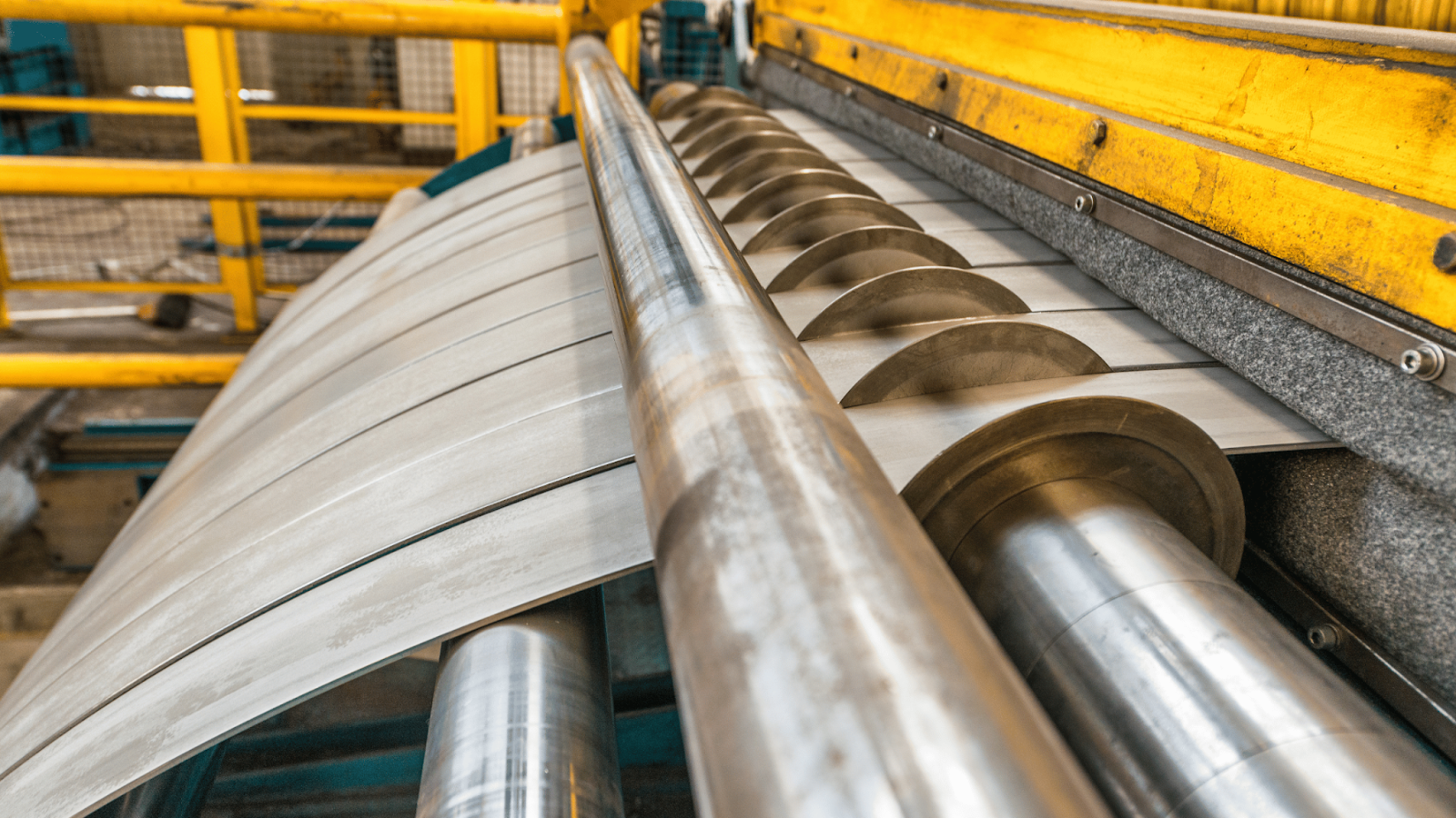 Various metal coils and sheets used in the stamping process, including steel, aluminum, and copper.