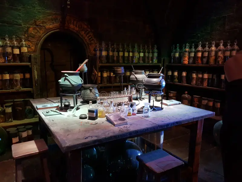 inside of the cauldron magic bar in London. On the table are many cauldrons