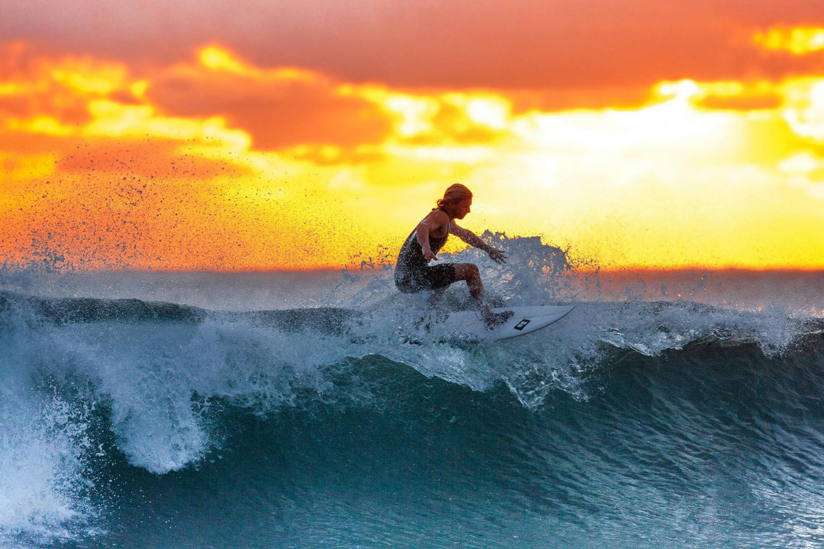 a girl surfing during the sunset in Bejuco 