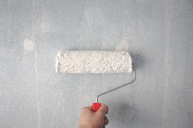 paint roller being used on the wall