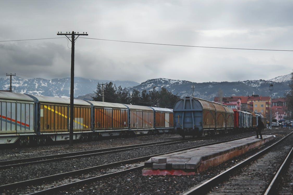 Free Train Running on Train Track Under Gray Sky at Daytime Stock Photo