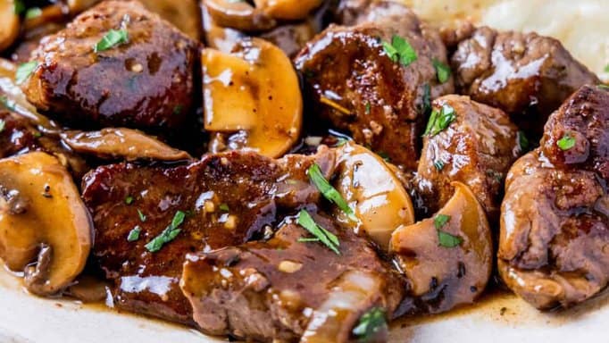Beef Tenderloin Tips in Mushroom Gravy on a white plate.