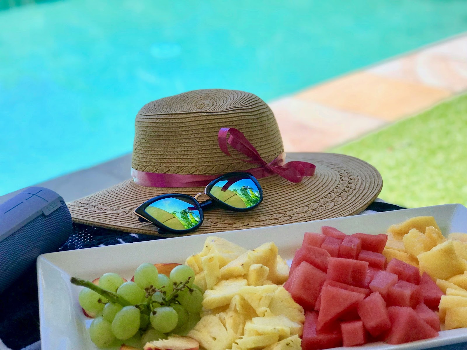 A guest indulging in a fruit tray by the pool at the Four Seasons Resort Lāna‘i.