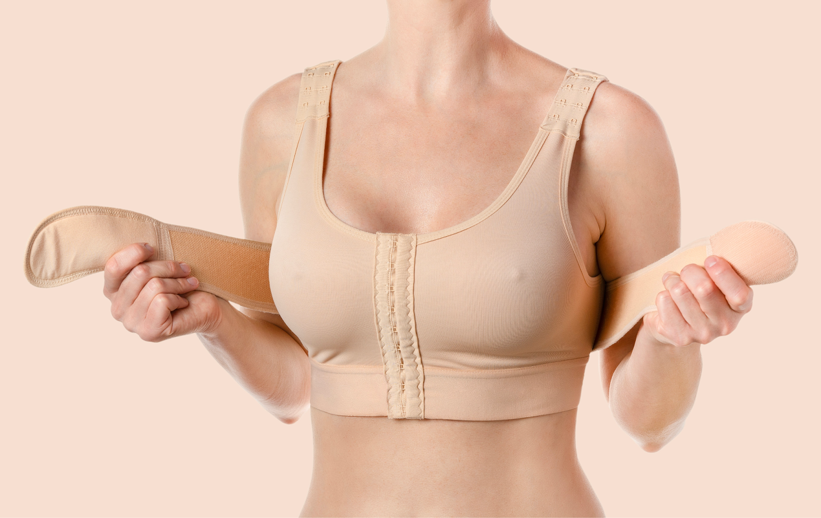 Woman wearing a post-surgery support bra after body fat transfer to breast.