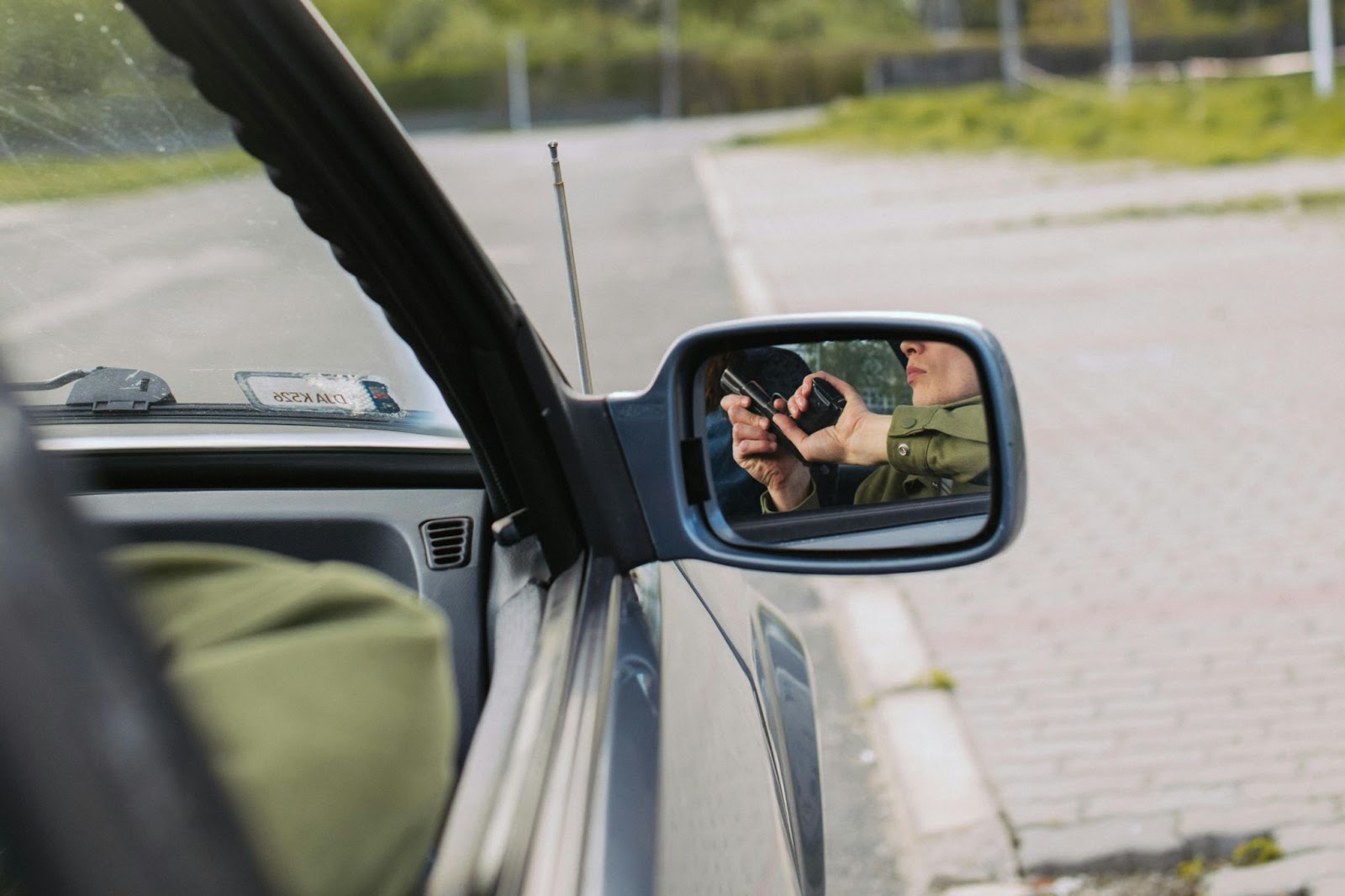 A man holding a gun in a car