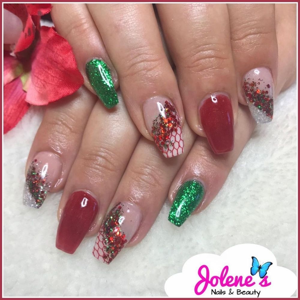 Close up of hands with Christmas Green Nails having  Red and Green Glitter Glam