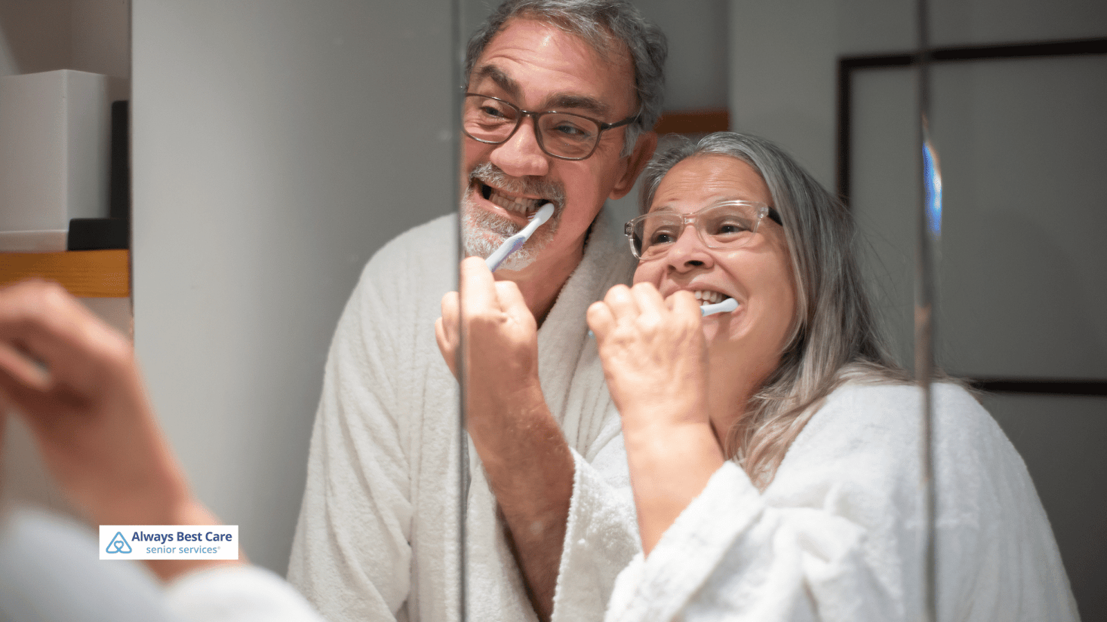 This is an image depicting two seniors brushing their teeth