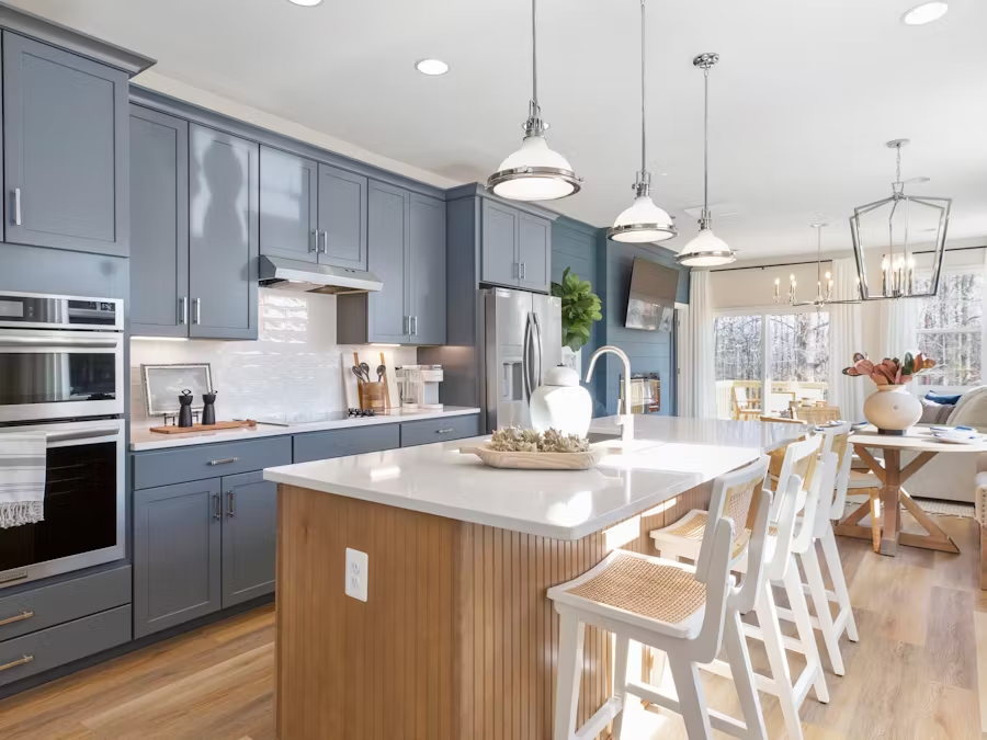 A newly built two-story townhome with a modern exterior, windows, and a garage