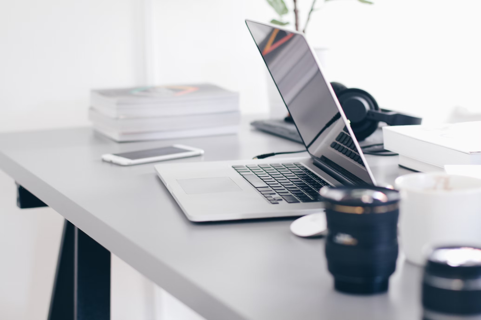 MLA short story citation.
An open laptop sits on a desk next to a phone and some textbooks. 
